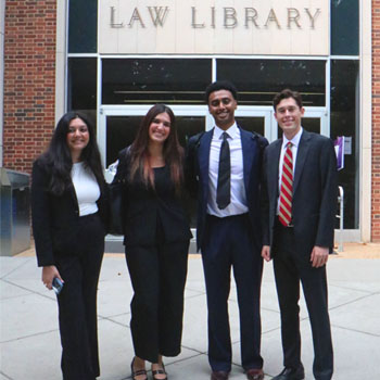 four incoming first-year students in from of the law library entrance