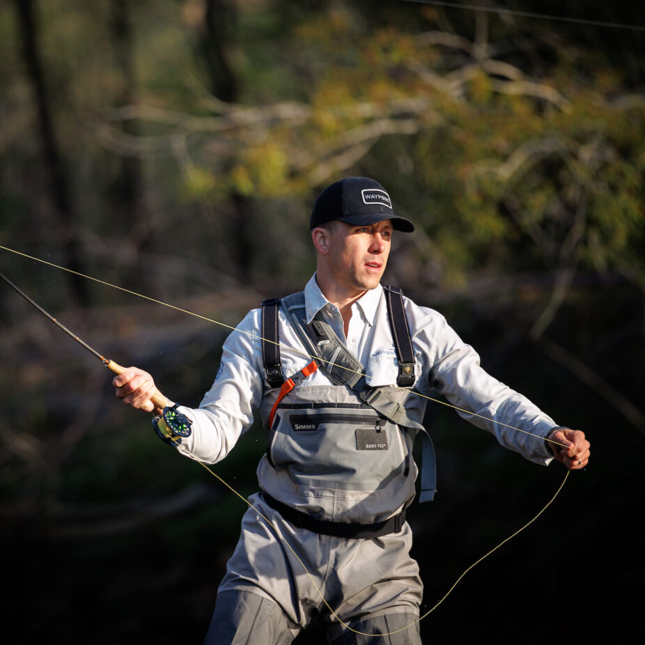 Alumnus Builder Brock fly fishes in a pristine river