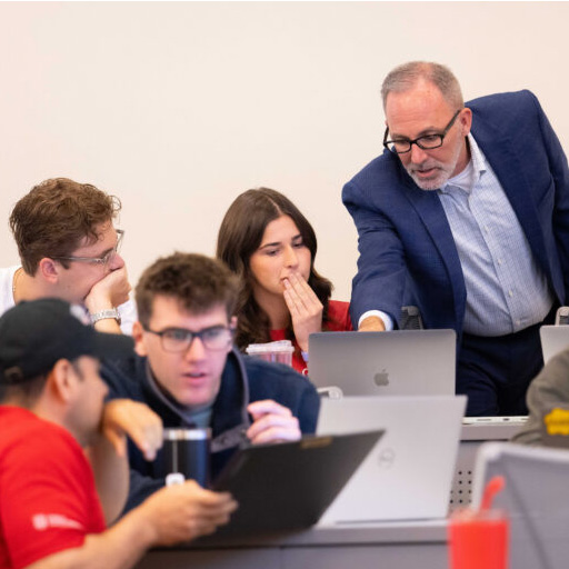 Georgia MBA director Jason Mathews works with MBA students in UGA classroom.